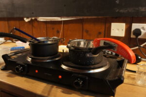 stoves with pans on to emulsify the oil and water to make natural organic skincare products